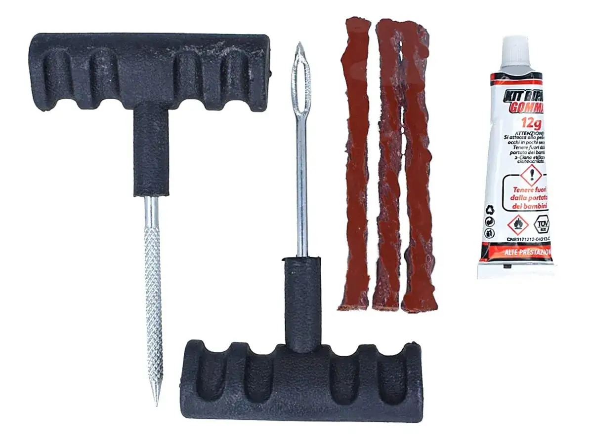 Kit per riparare gomma bucata: attrezzi, fili di gomma e colla. Ideale per emergenze su strada.